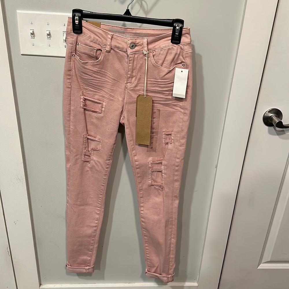 Pink distressed skinny jeans